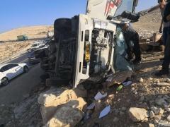 (صور) انقلاب شاحنة بضائع على طريق الكسارات