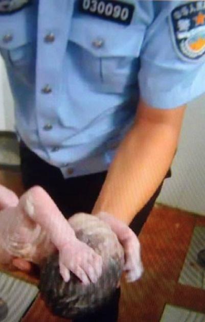 صور مؤثرة لشرطي صيني ينقذ رضيعة من الموت في دورة مياه عمومية